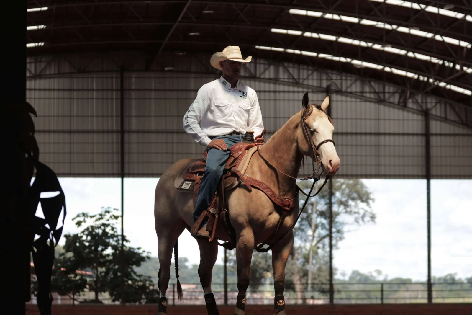 JBJ Ranch rider on a buckskin Quarter Horse